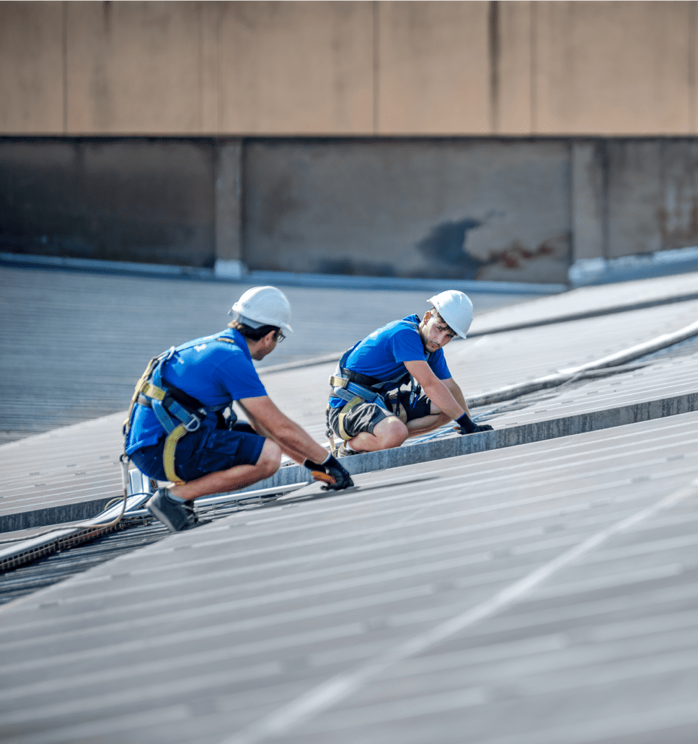 Roof installation by two workers