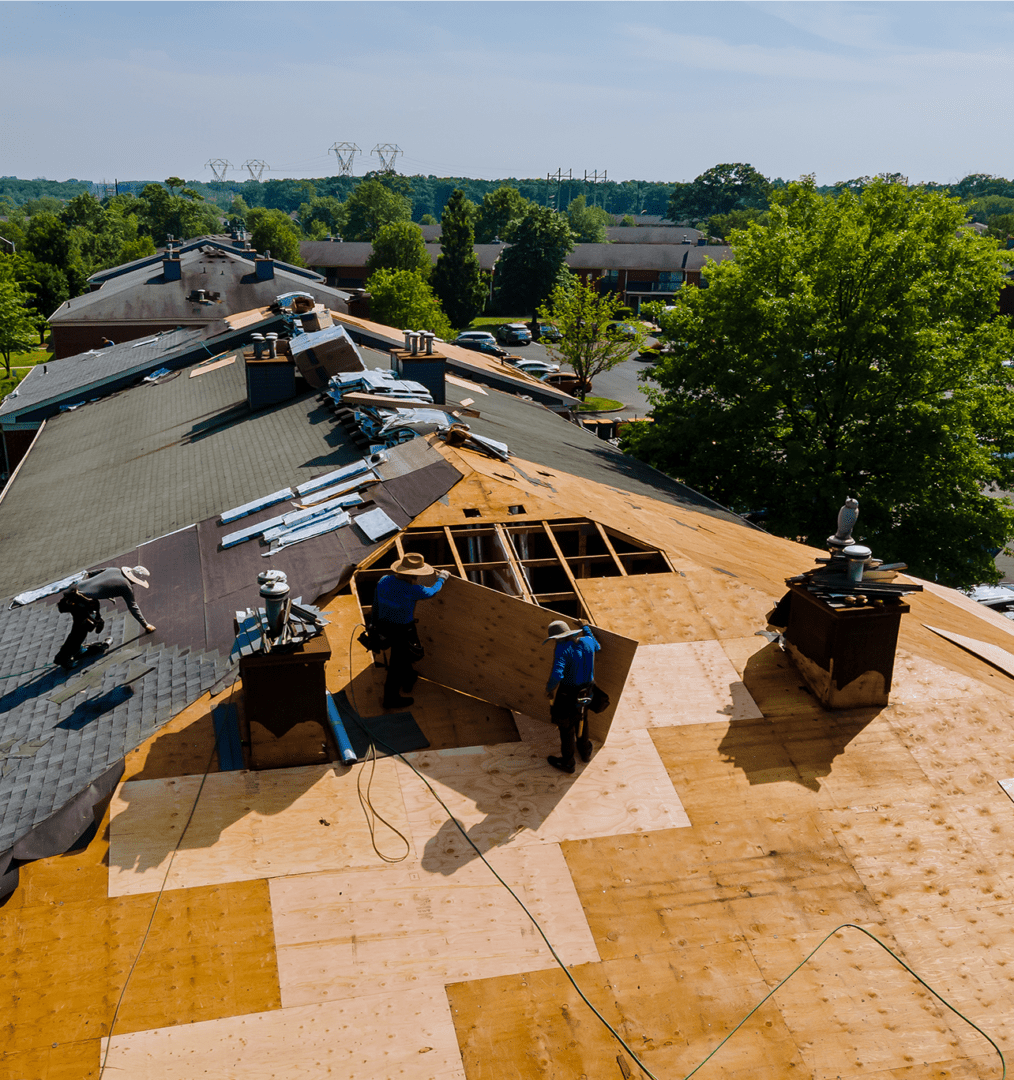 Roofers working on building roof renovation