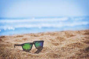 Sunglasses on sand near beach in Virginia